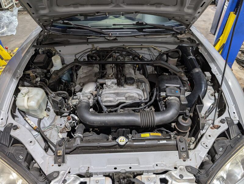 The engine bay with the Randall Cowl Intake from Flyin' Miata.
