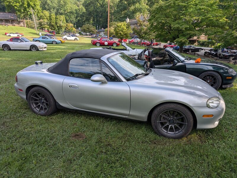 The Miata parked on the grass show field at Miatas at the Gap among other Miatas, top up.